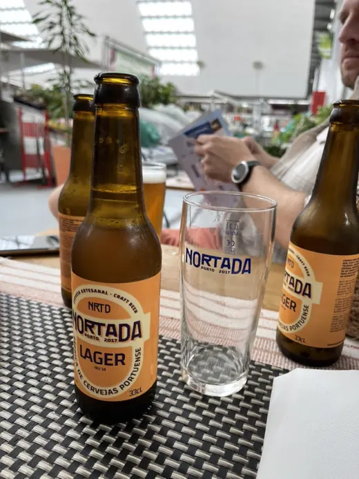 Two bottles of Nortada Lager craft beer on a table at a Rally Fish stop