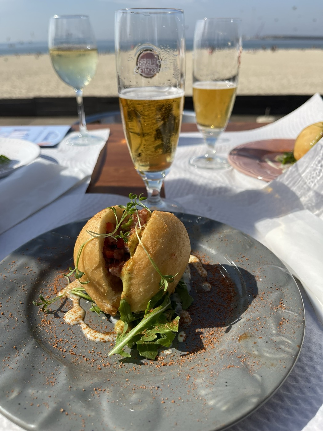 A grilled fish sandwich and a beer at a Rally Fish stop